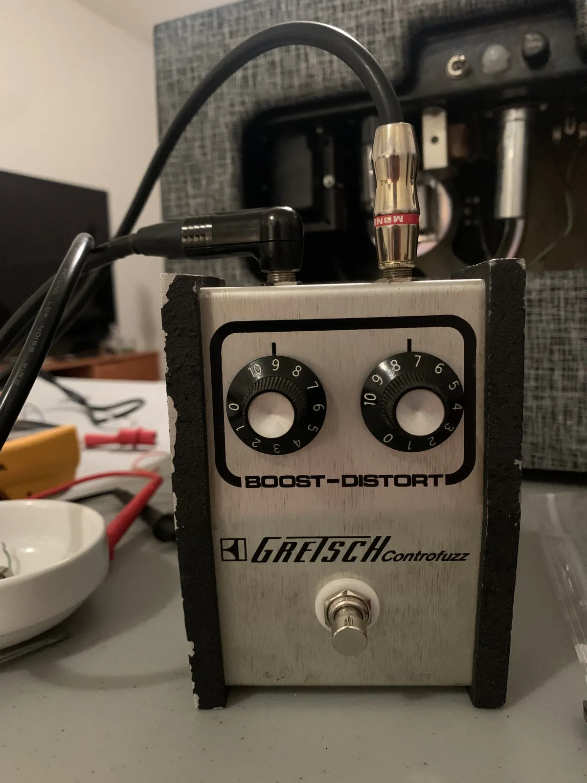 Gretsch Controfuzz Boost-Distort pedal plugged in on the bench in front of an amplifier