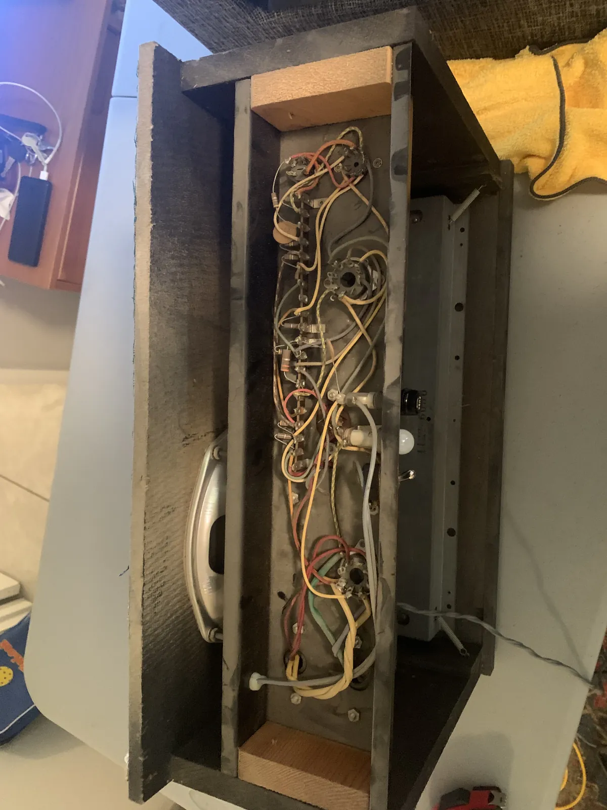 Supro cabinet with the back open showing the chassis wiring and speaker