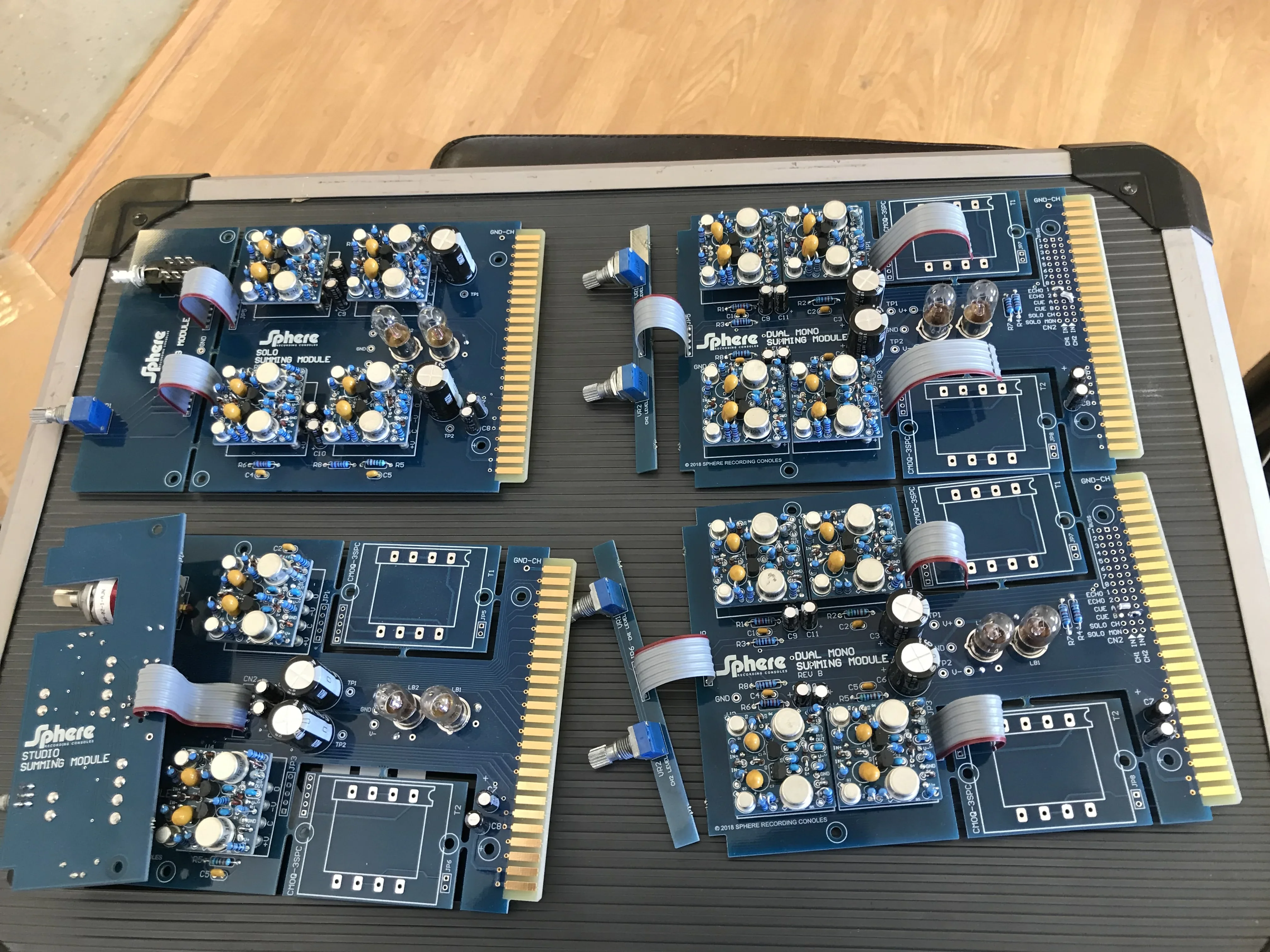 Several Sphere console modules with populated op amp boards laid out on a bench